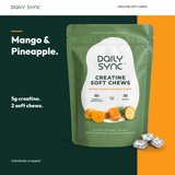 Daily Sync Creatine Soft Chews in Mango & Pineapple with three individually wrapped chews on a forest green and orange background