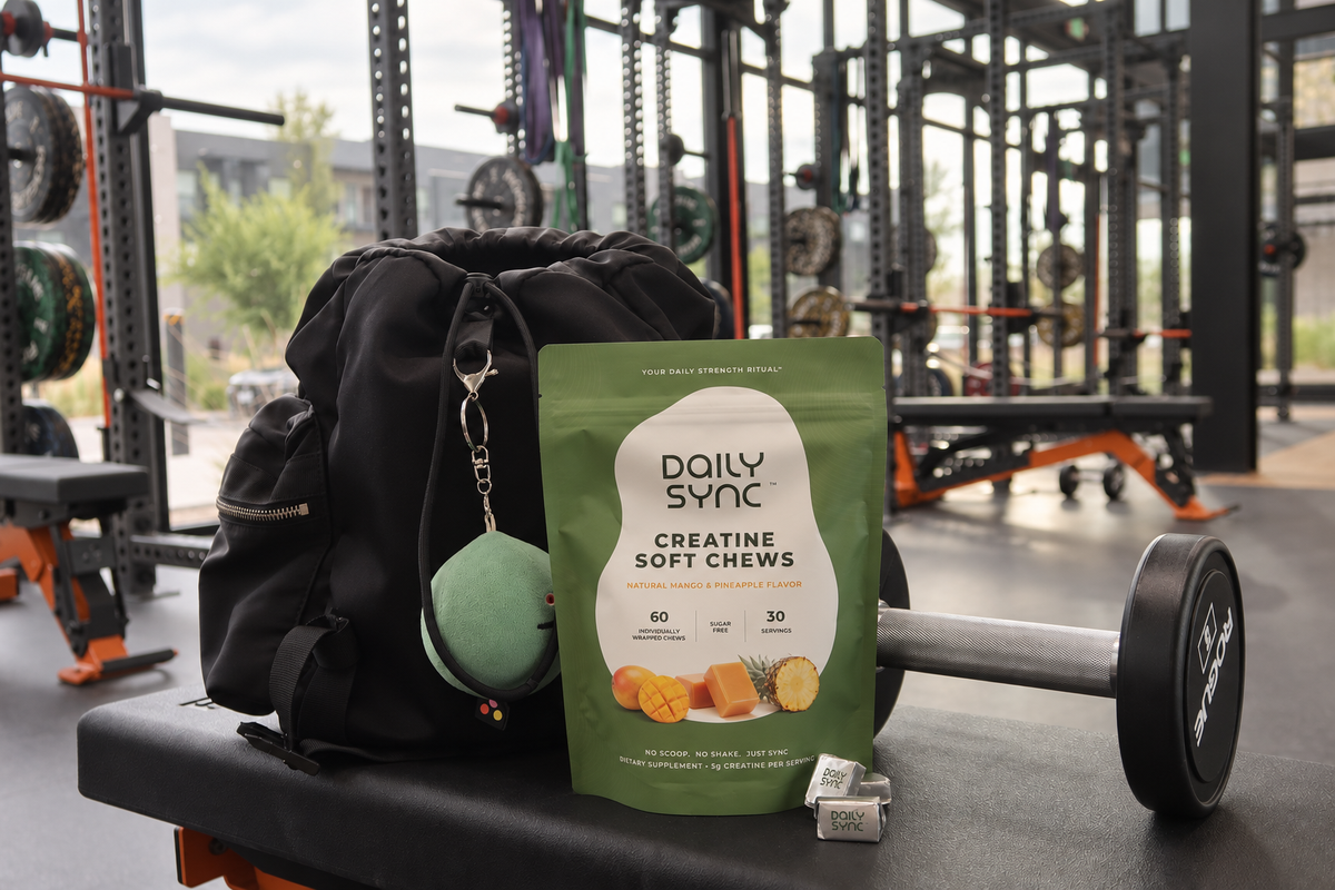 Daily Sync creatine pouch and individually wrapped chews on a gym bench